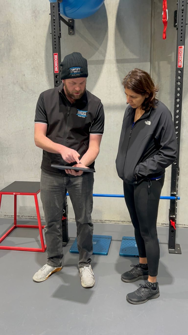 a man and woman standing in a gym